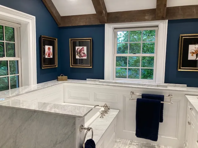 Bathroom with marble tub and navy walls